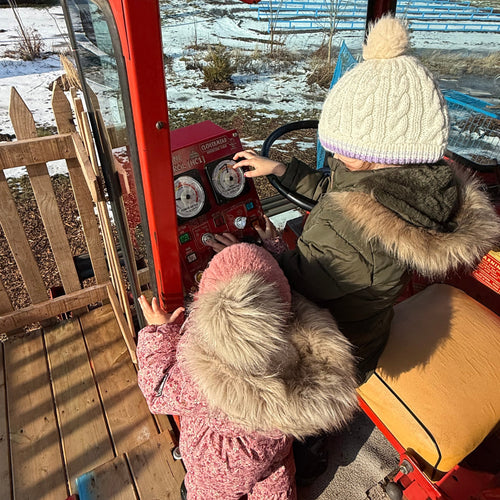 Two children interacting with Harvest Control console